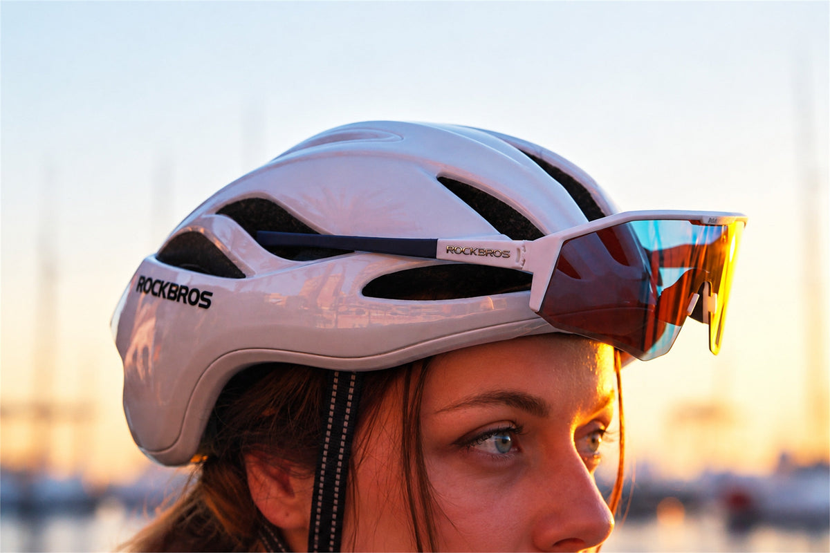 Close view of a rider wearing a ventilated bicycle helmet and cycling glasses