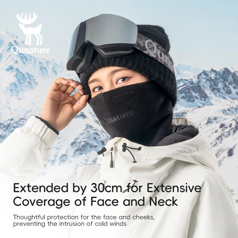 Person wearing a black balaclava with extended coverage in a snowy mountain setting, featuring the brand 'Qunature'.