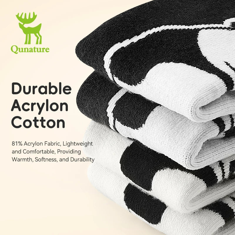 Stack of black and white socks with Qunature branding and product details on a beige background