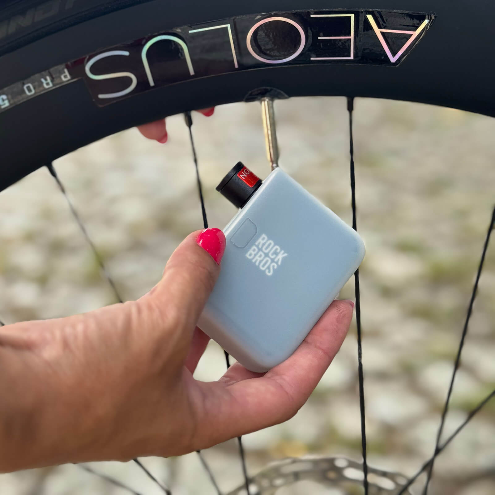 rockbros as1 pro mini electric air pump inflating road tyre to 120 psi, compact design with digital display