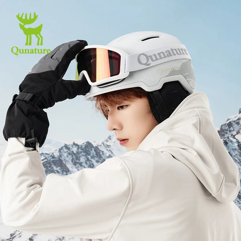 Person wearing a white helmet and goggles with Qunature branding, set against a mountainous background.