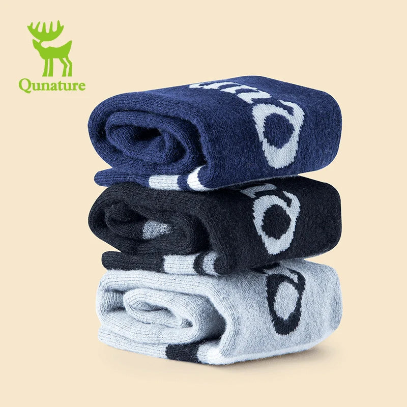 Three folded wool blend children's ski socks in different colors with thickened fine terry lining