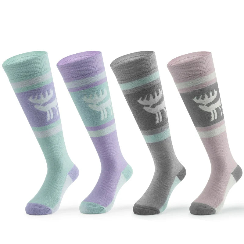 Four warm knee-high ski socks in different colors with a reindeer pattern