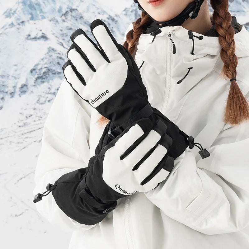 Person wearing black and white gloves with a snowy background