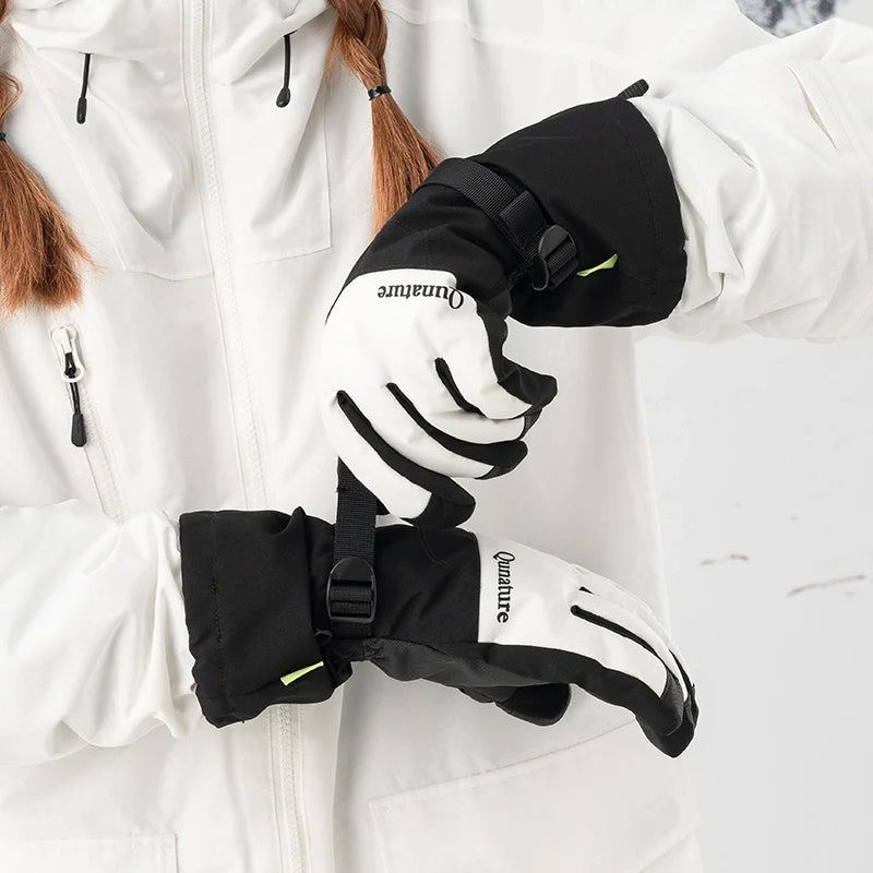 Black and white gloves with visible branding worn by a person in a white jacket.