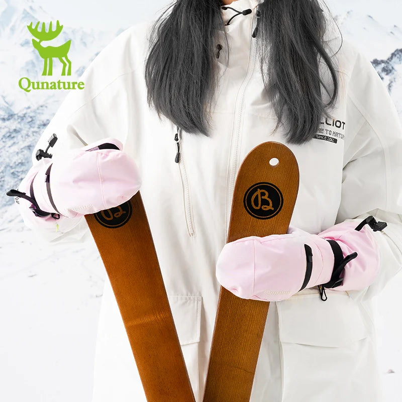 Person wearing a white jacket with pink gloves holding wooden clubs, Qunature logo visible.