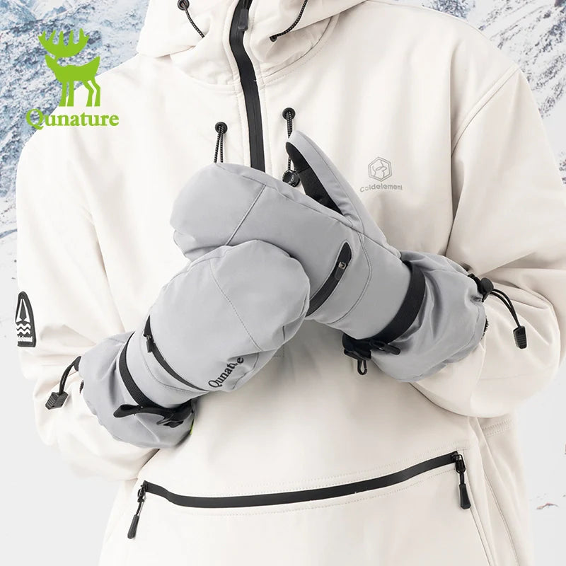 Person wearing gray gloves and a white jacket with a brand logo against a snowy background