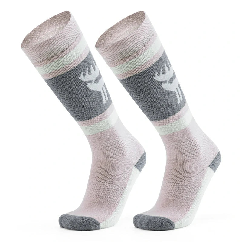 A pair of pink wool ski socks with a striped design and a reindeer logo on the ankle#Color_Pink